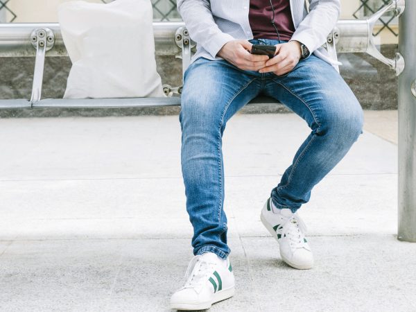low-section-man-using-smartphone